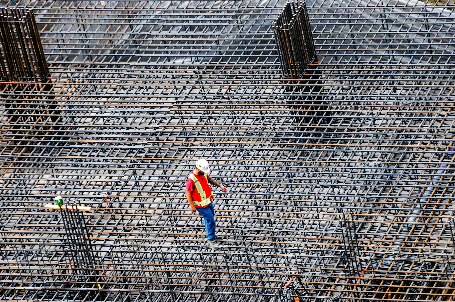 Construction worker inspecting rebar on site